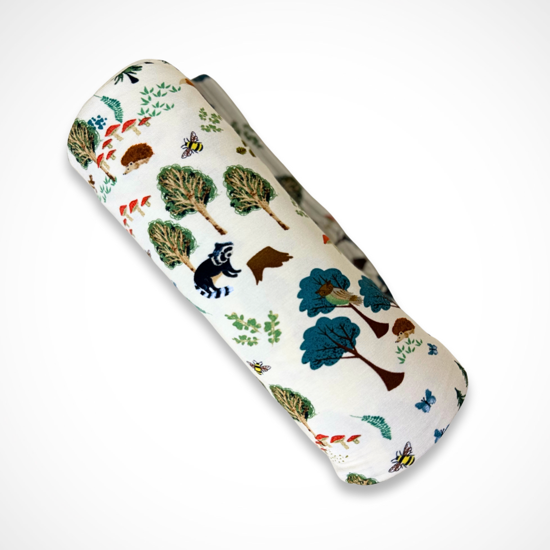 Bamboo receiving blanket with forest animal pattern on a white background